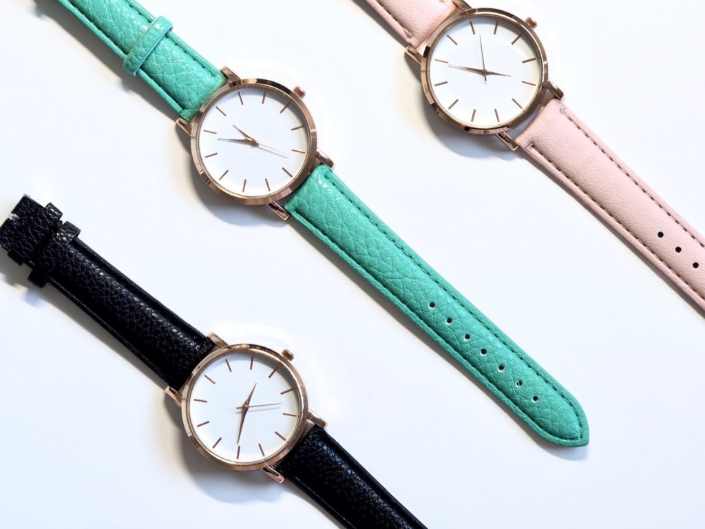 three round assorted-color analog watches with leather straps