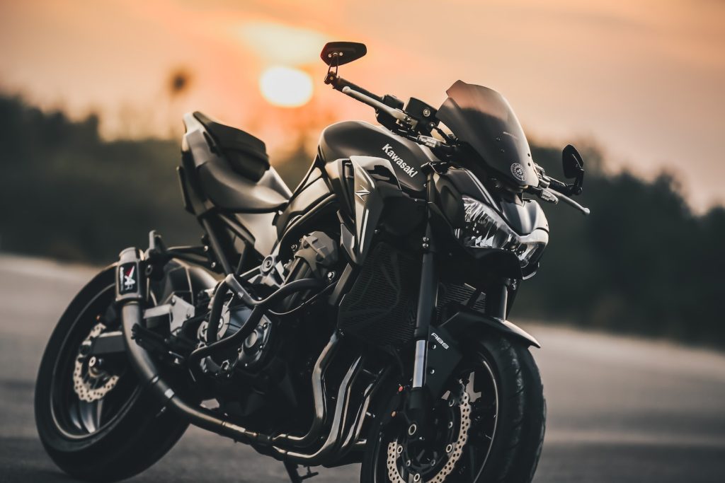 black and gray motorcycle on gray asphalt road during sunset